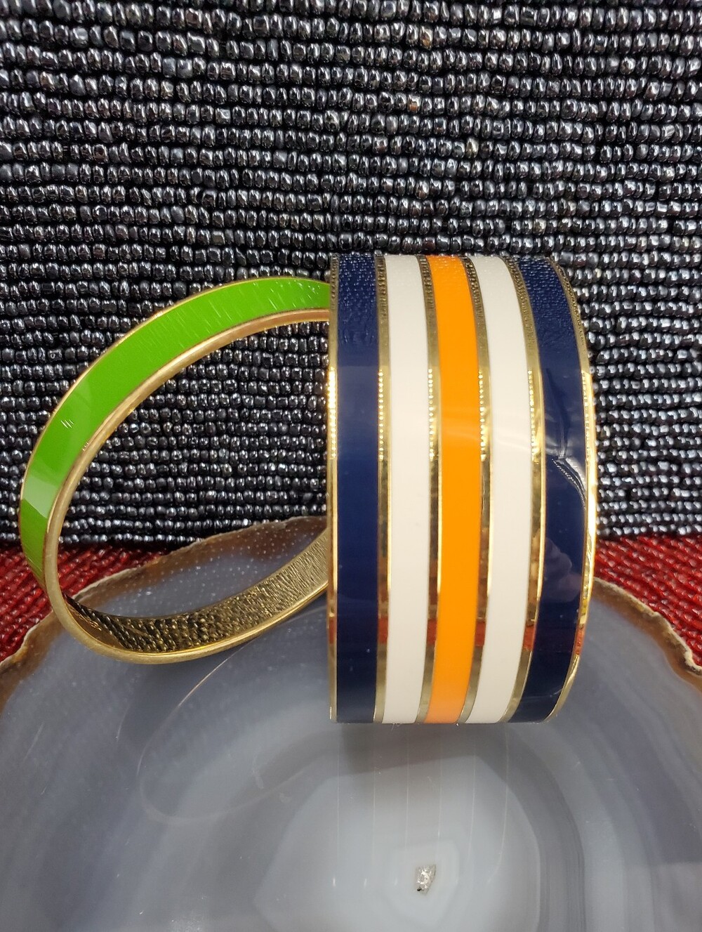 Two vibrant enamel and gold-plated bangle bracelets from Kate Spade New York.